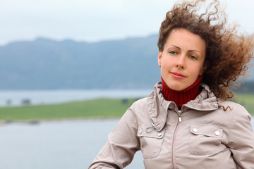 beautiful woman is on board ship and looks into distance