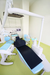 Empty dental clinic. Chair for patient and drill for dentist