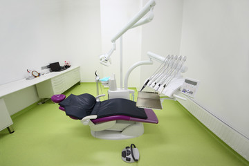 Empty dental clinic. Chair for patient, table with computer