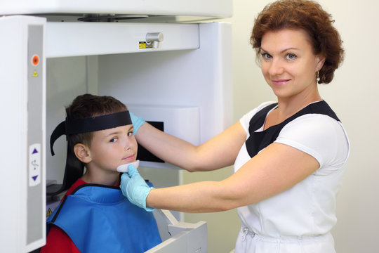 Dentist prepares boy wearing in protective lead