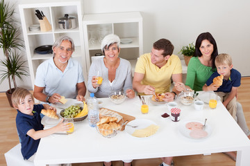 Happy family having breakfast together