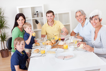 Happy family having breakfast together