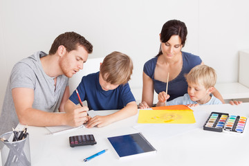 Young family drawing with colorful pencils