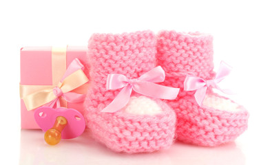 pink baby boots, pacifier and gift isolated on white