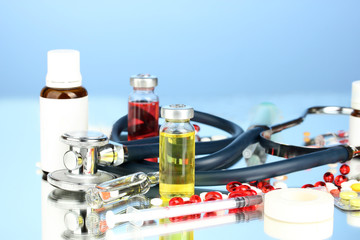 medicines and a stethoscope on a blue background close-up