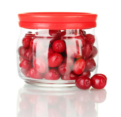 fresh cornel berries in glass jar isolated on white