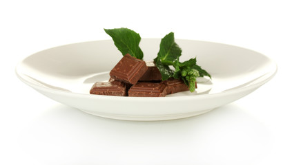 Pieces of chocolate and mint on the plate isolated on white