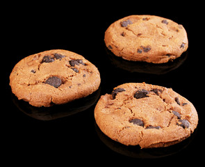 Chocolate chips cookies isolated on black