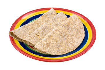 Whole wheat tortillas folded on plate