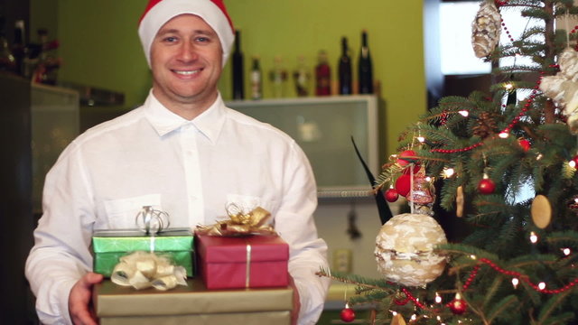 Portrait of young man with christmas gifts