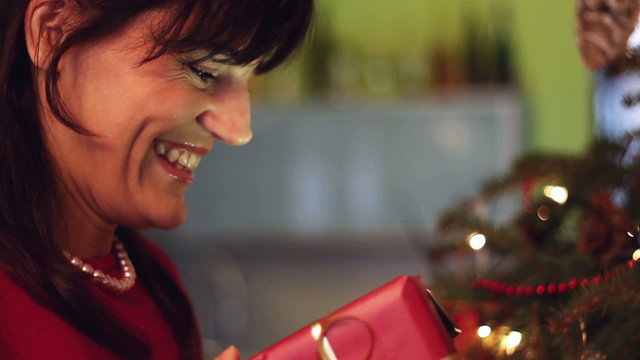 Young woman opening x-mass present