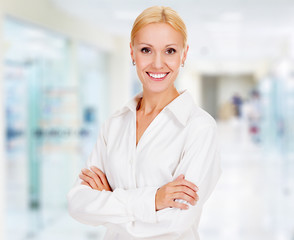 Fototapeta premium young business woman in the office smiling to you