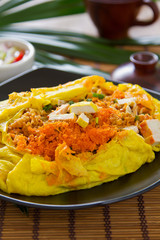 Stir fried  wrapped in omelete [Thai 's food]