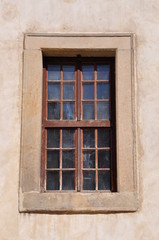 Window with steel bars on the wall of the castle