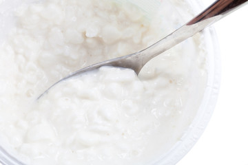 spoon in tub of cottage cheese