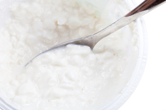 spoon in tub of cottage cheese