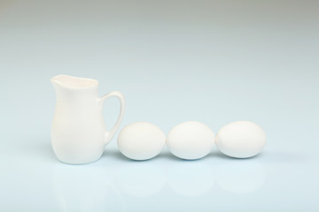 Milk in a glass jar and eggs