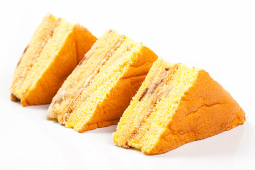 3 peice of yellow cake on a white background