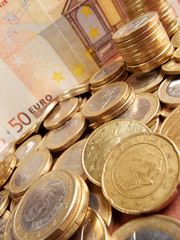 Euro coins on banknote money background