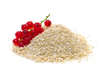 oat bran with red currants on a white background