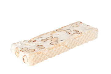 White nougat bar with almonds over a white background