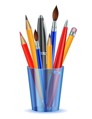 Brushes, pencils and pens in the holder.