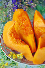 pieces of a fresh pumpkin on a table.
