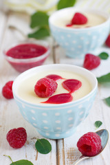 Lemon panna cotta dessert with raspberry sauce