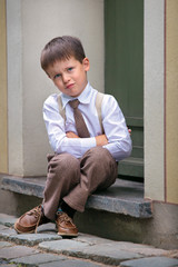 Portrait of a happy little boy outdoors in city