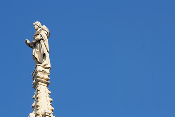 Fototapeta premium Ancient marble statue over the Milan cathedral