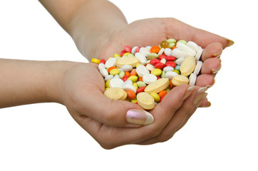 Hands holding pills on white