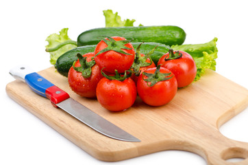 Tomatoes and cucumbers on white