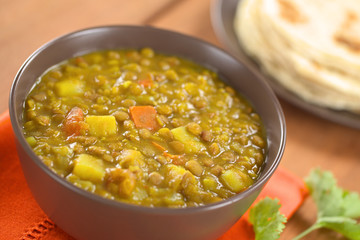Bowl of spicy Indian dal (lentil) curry with carrot and potato