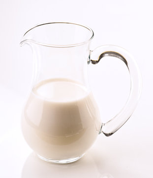 full milk glass pitcher; isolated on white