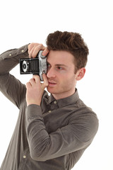 Fototapeta premium Young adult male with olf film camera