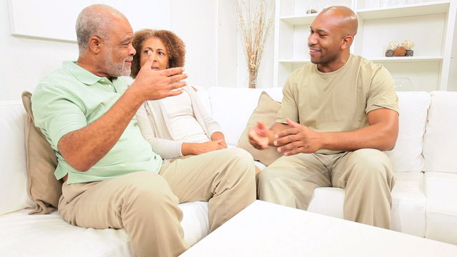 African American Parents Relaxing Son Home