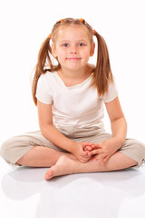 Beautiful little girl sitting and smiling