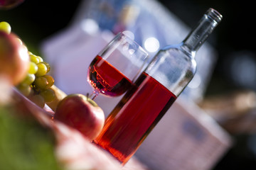 Wine and picnic basket on the grass 
