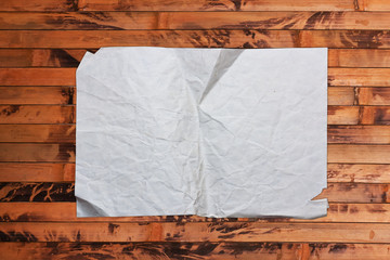 Blank crumpled paper on a wooden background