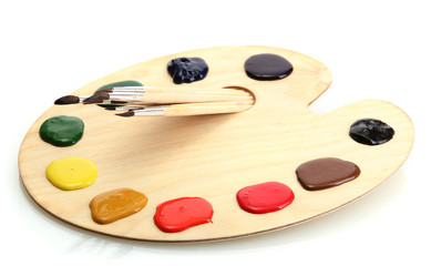 wooden art palette with  paint and brushes.isolated on white