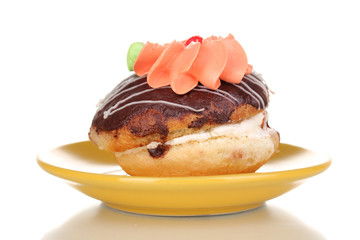 sweet cake with cream on saucer isolated on white