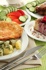 Roast chicken cutlet with boiled potatoes and  vegetables, cup