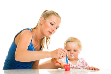Obraz na płótnie Canvas Cute infant girl learining to eat with spoon