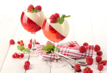 fruit jelly with berries in glasses on wooden table