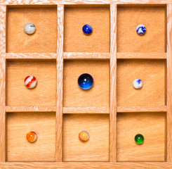 Shadow box with collection of marbles