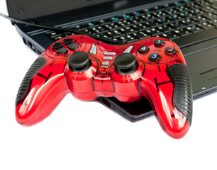 red joystick game controller on laptop .
