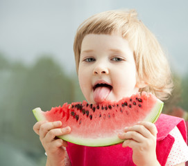 Funny little girl with watermelon