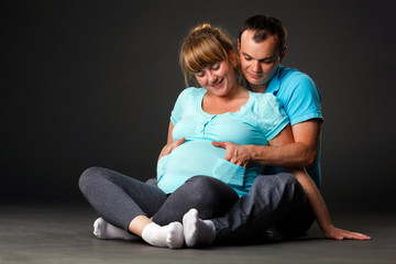 Portrait of happy young family together waiting for baby