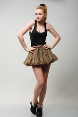 A beautiful young woman is in dark  clothes