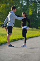 Couple doing stretching exercise  after jogging